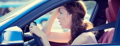 Side view window portrait displeased stressed angry pissed off woman driving car annoyed by heavy traffic isolated street background. Emotional intelligence concept. Negative human face expression
